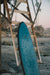 A midlenght alchimie surfboard in daylight on lifeguard tower.